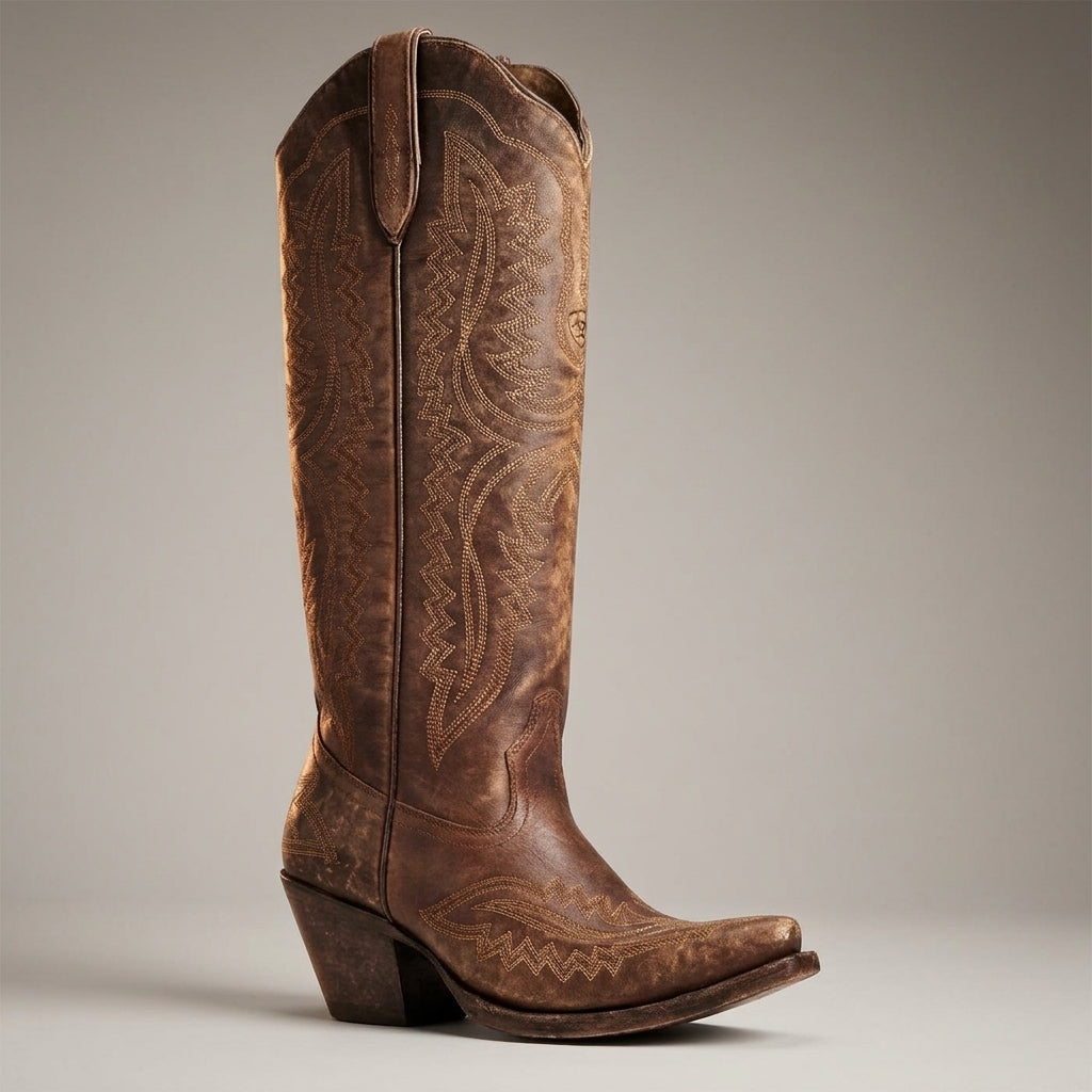 Chocolate brown cowboy boots with embossed western detailing, pointed toe, and block heel