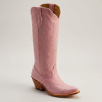 Light pink cowboy boots with western stitching, pull-on shaft, and wooden block heel