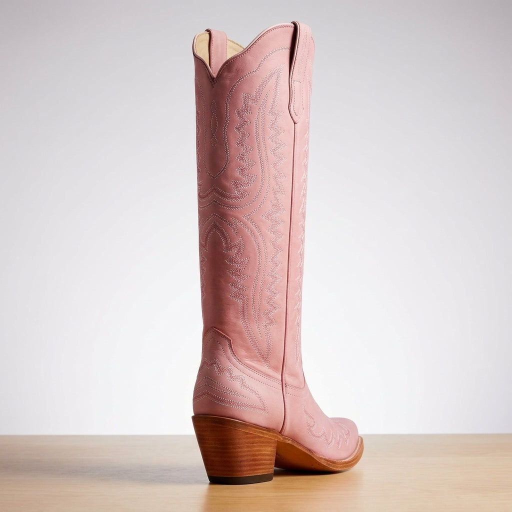 Rose pink cowboy boots with embossed western patterns, side pull panel, and wood heel
