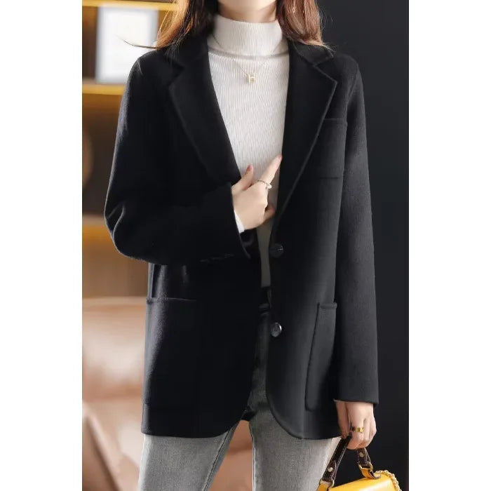 Black wool blazer with notched lapels, two-button front, and side flap pockets
