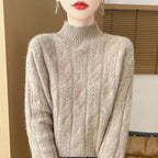 Light gray cable knit mock neck sweater, textured front cables and ribbed cuffs and hem.