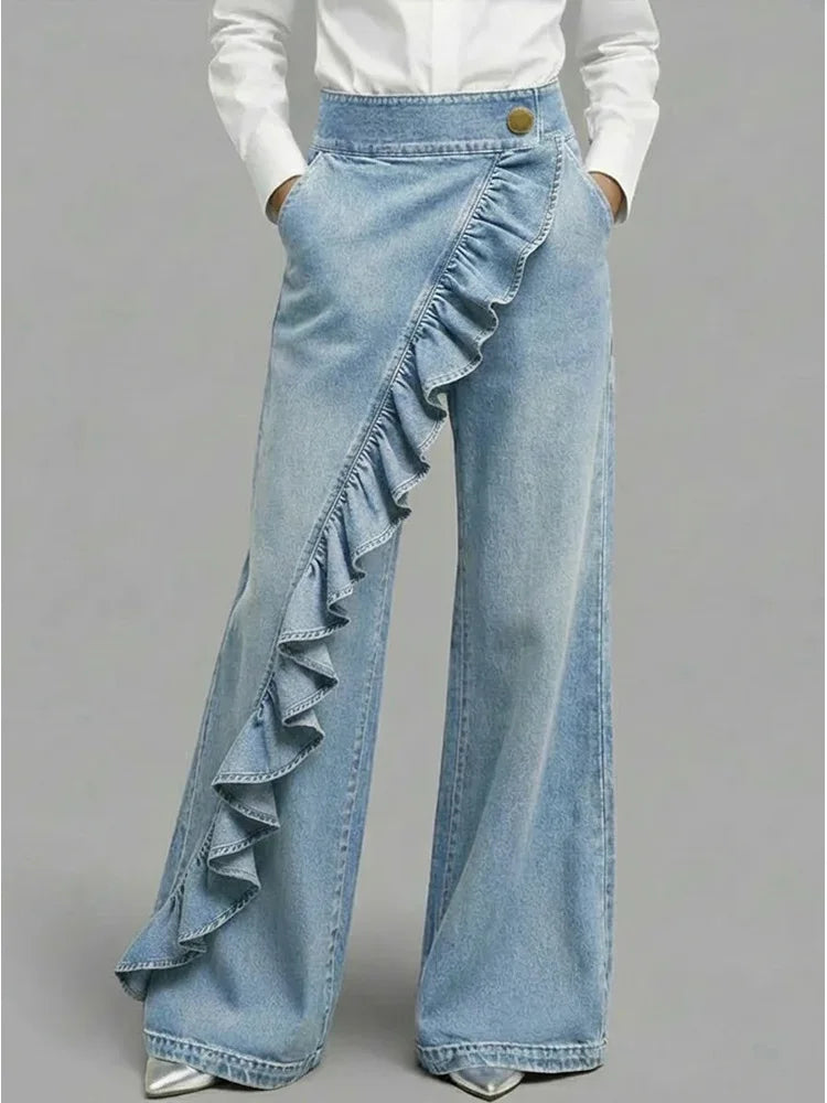 Light blue wide-leg jeans with diagonal ruffle overlay and gold button waistband