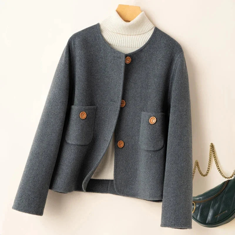 Dark gray button-front jacket with ribbed high collar and two patch pockets.