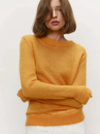 Mustard yellow crewneck knit sweater with long sleeves and ribbed hem