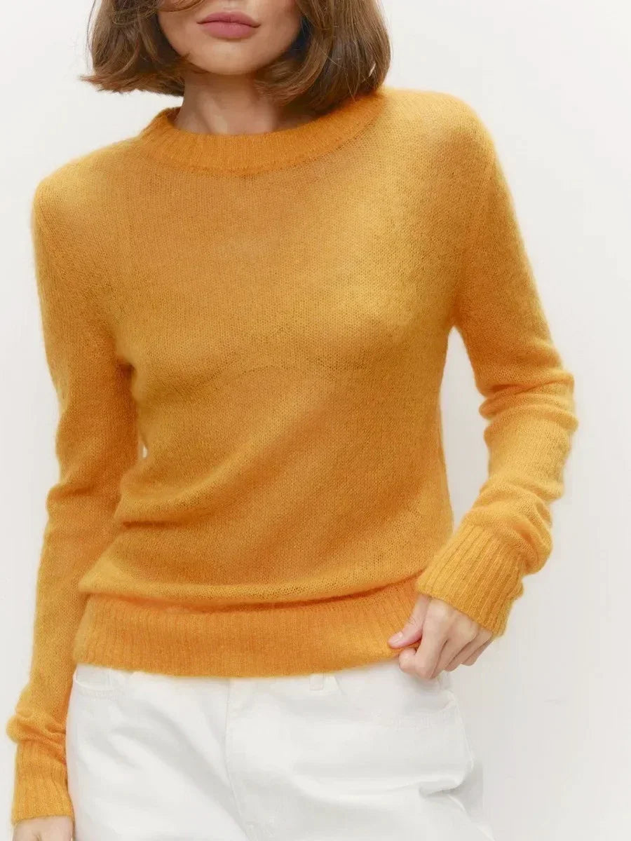 Lightweight crewneck knit sweater in mustard yellow with long sleeves and ribbed cuffs.