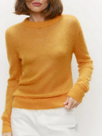 Lightweight crewneck knit sweater in mustard yellow with long sleeves and ribbed cuffs.