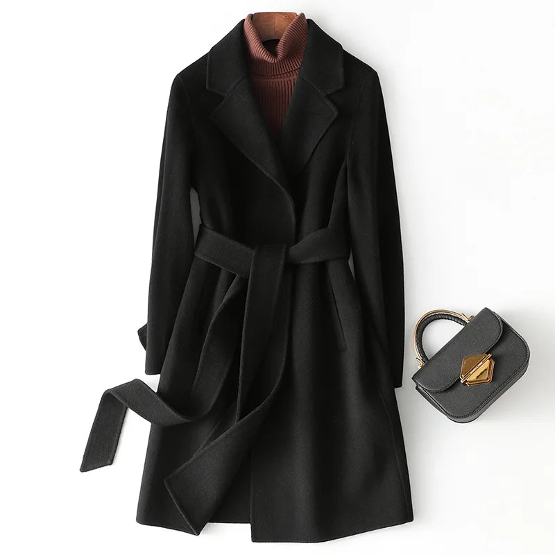 Black belted wool midi coat with lapels, tie belt, and front patch pockets