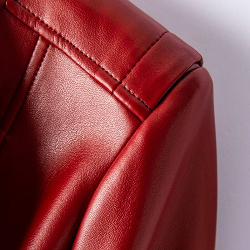 Crimson red leather jacket sleeve and shoulder with stitched seam and button-tab detail