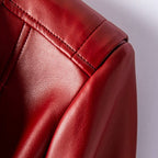 Crimson red leather jacket sleeve and shoulder with stitched seam and button-tab detail
