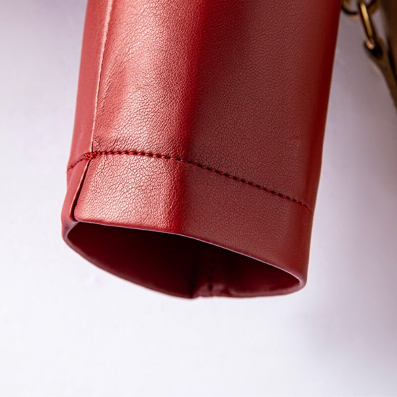 Crimson red leather jacket hem with stitched cuff edge, close-up