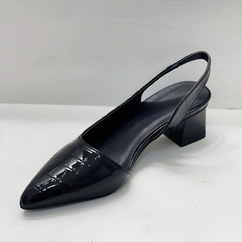 Black patent leather-look mule heels with pointed toe and mid block heel