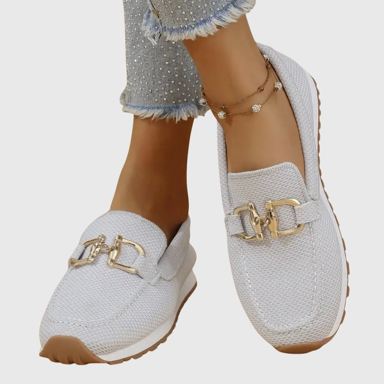 White orthopedic loafer shoes with textured knit, gold buckle-bit detail, brown sole