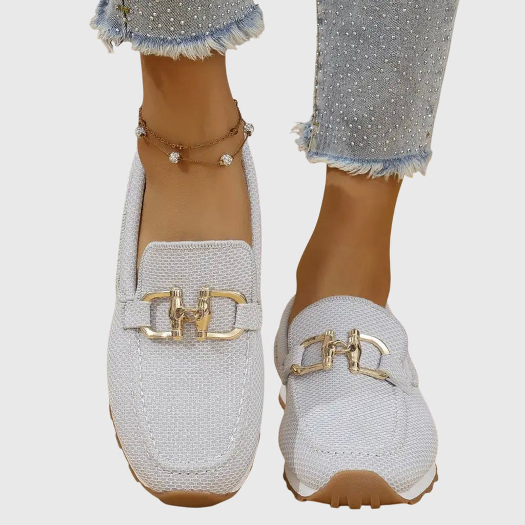 White orthopedic loafer shoes with gold buckle-bit ornament on textured knit upper