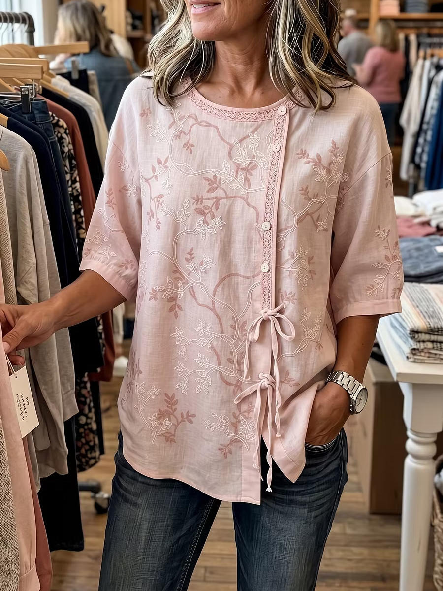 Pink floral embroidered blouse with lace-trim round neck, button front and side draw ties