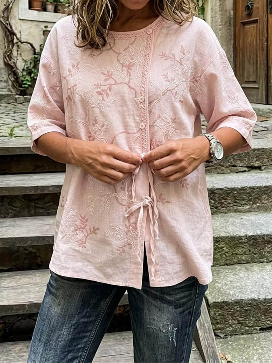 Pink floral embroidered blouse with lace-trim round neck, button front, side drawstrings