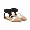 Two-tone pointed-toe flats with dark ankle strap, cream uppers and gold trim