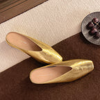 Gold metallic leather flats with pointed toe and low heel, slip-on design