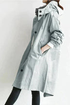 Light grey womens waterproof raincoat with oversized hood and buttoned front