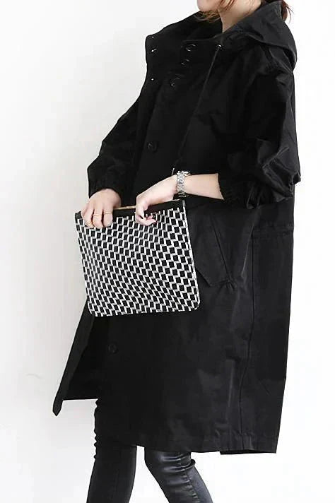 Black womens oversized waterproof raincoat with hood and snap-button front