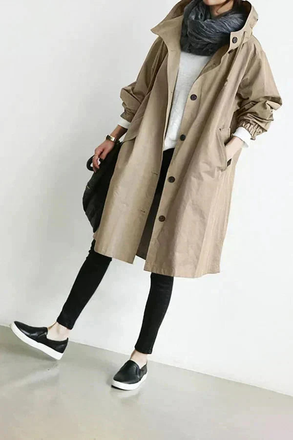 Beige womens waterproof raincoat with oversized hood and button front