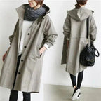 Grey womens oversized waterproof raincoat with hood, button front, and long sleeves