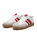 White low-top sneaker with red stripes, lace-up design, tan rubber sole.