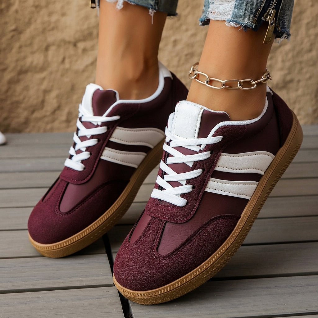 Maroon and white lace-up sneakers with striped side panels and tan rubber sole.