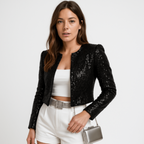 Black sequin cropped blazer with open front and long sleeves, styled with white shorts