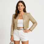 Gold sequin cropped blazer jacket with open front and long sleeves, worn over a white top