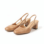 Beige leather heeled mule with open back and block heel, close-up