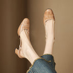 Beige leather heeled mule with open back and block heel, side view
