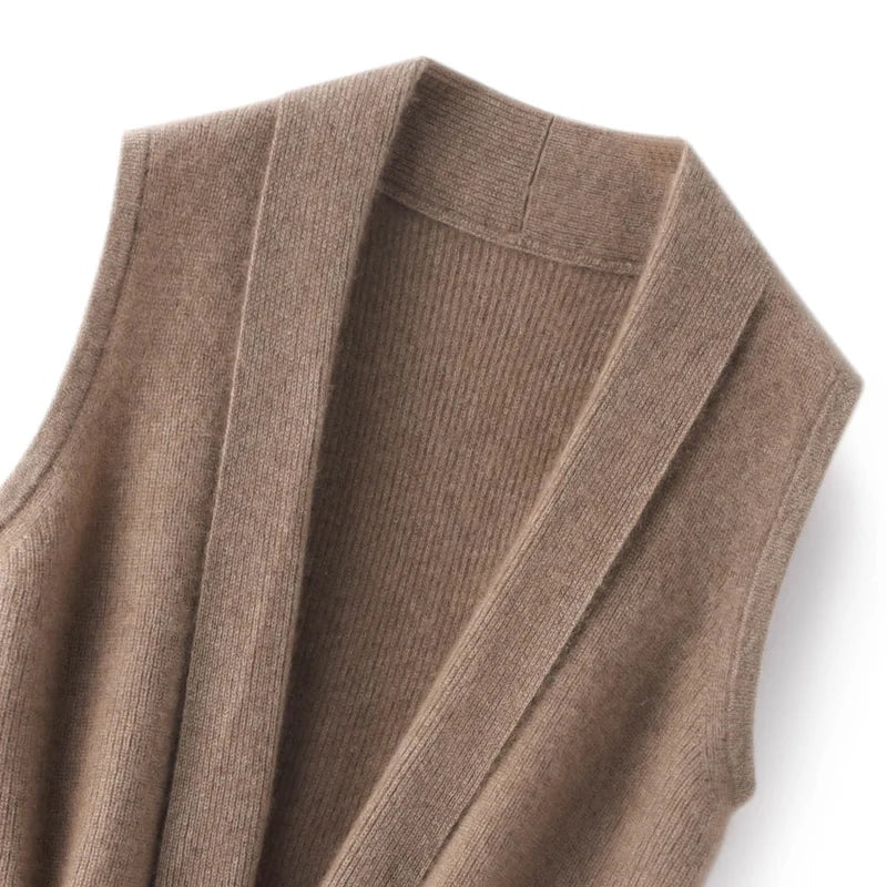 Camel merino wool sweater vest knit, showing ribbed collar and V-panel stitching detail.
