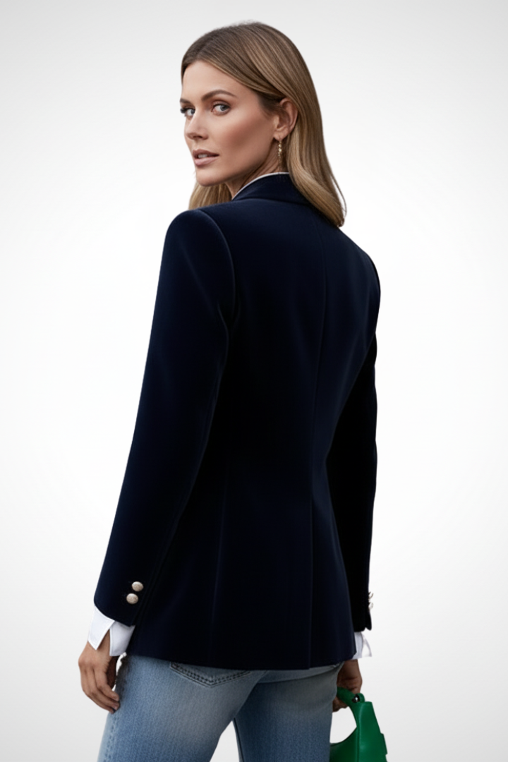 Navy women’s blazer with lapels and gold button, side view