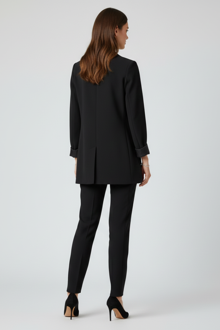 Women's black longline blazer with cuffed sleeves, back view