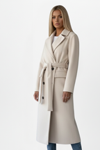 Women’s long double-breasted coat in cream with waist belt and structured shoulder seams