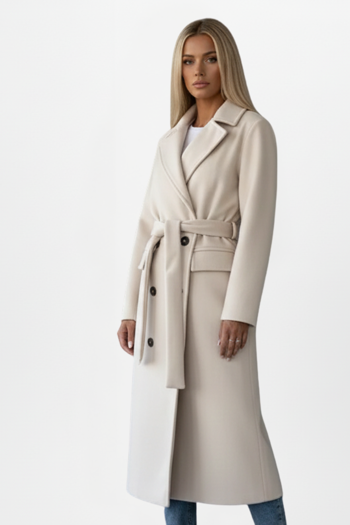 Women’s long double-breasted coat in cream with waist belt and structured shoulder seams