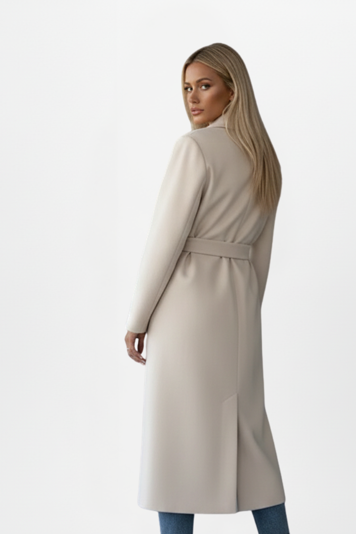 Women’s long cream belted double-breasted coat with notched lapels and side profile