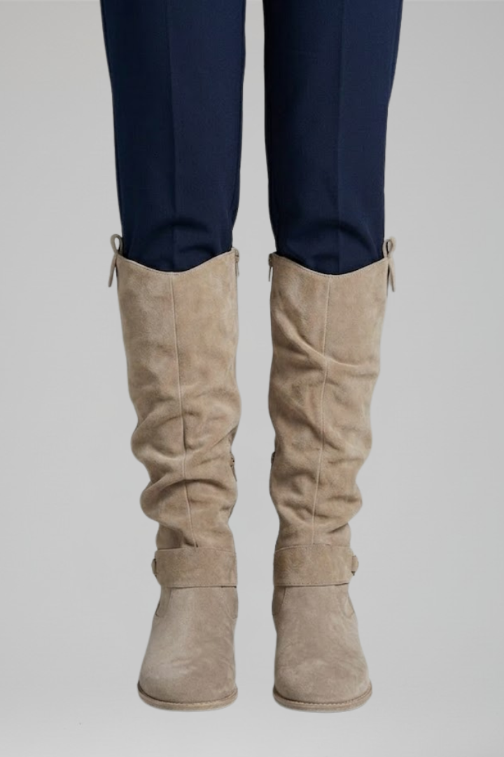 Beige knee-high boots with side seams and ankle strap, low stacked heel.