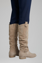 Beige knee-high boots with side zipper and ankle strap, stacked heel.