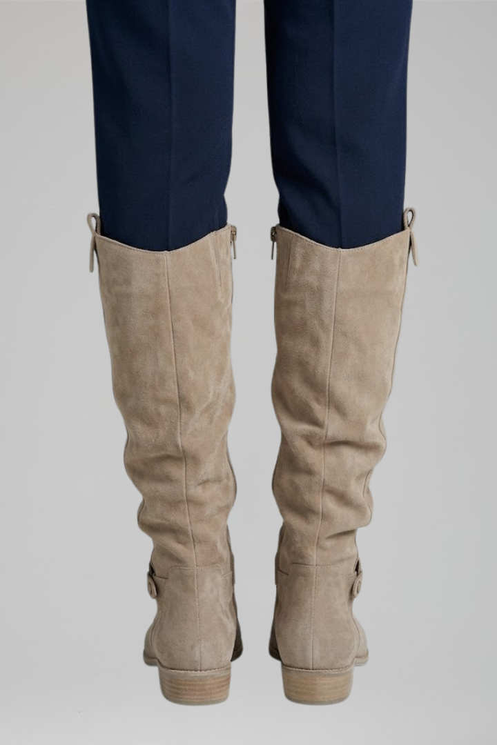 Beige knee-high boots, back view with pull tabs and ankle strap, low stacked heel.