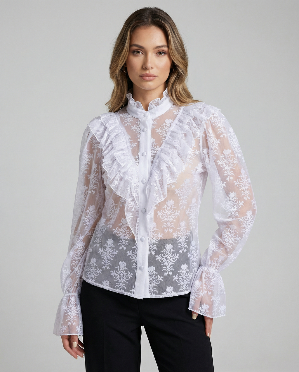 White sheer lace blouse with ruffled bib, button placket, and flared cuffs