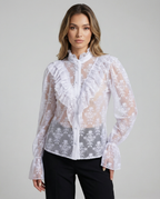 White sheer lace blouse with ruffled bib, button placket, and flared cuffs