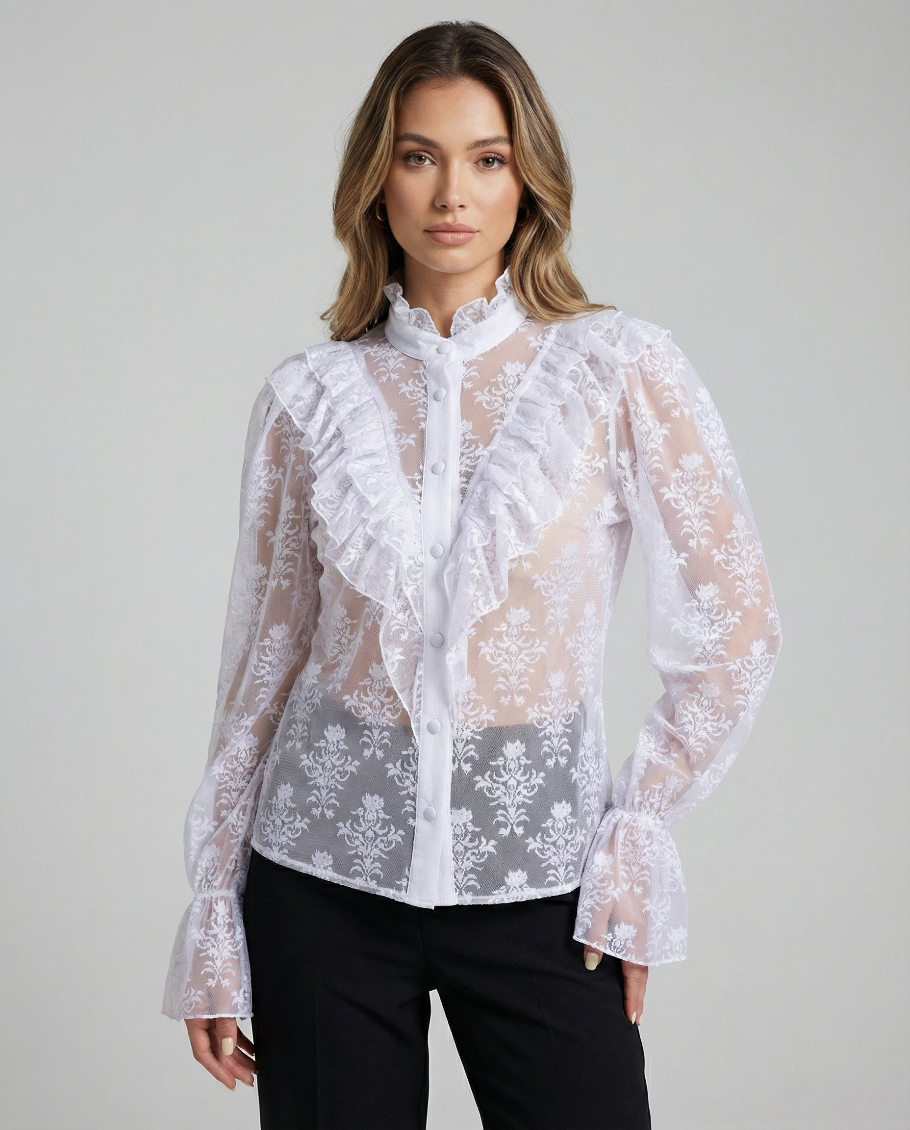 White sheer lace blouse with ruffled bib, button placket, and flared cuffs