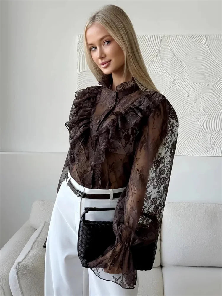 Brown sheer lace blouse with ruffled shoulders and long flared sleeves