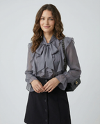 Gray chiffon blouse with ruffled bow neckline and long sheer puff sleeves