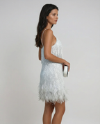 Shimmering white mini dress with spaghetti straps and feather fringe hem