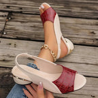 Red and white slide sandal with open toe, low block heel, chain ankle strap
