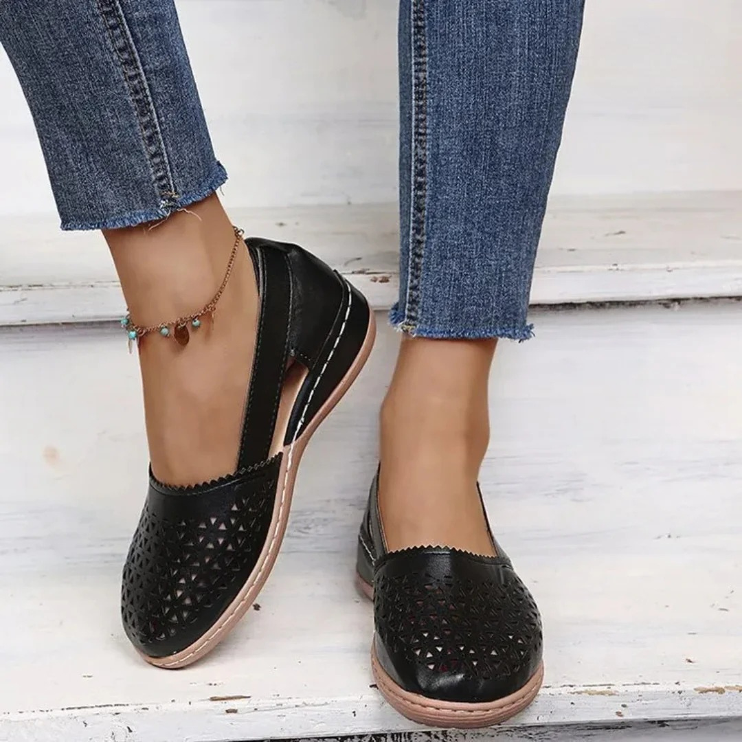Women’s comfort walking shoes in black with perforated slip-on design