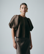 Dark brown satin blouse with short puff sleeves, crew neck, and center-front seam