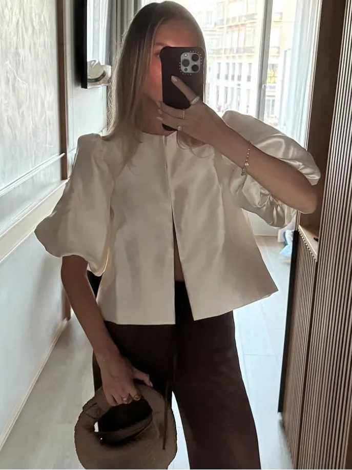 Ivory satin blouse with short puff sleeves and center-front seam